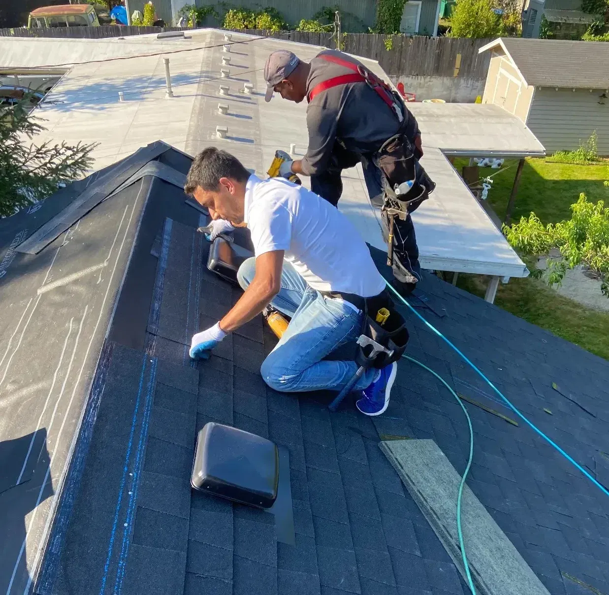 Roofing professionals installing asphalt shingles